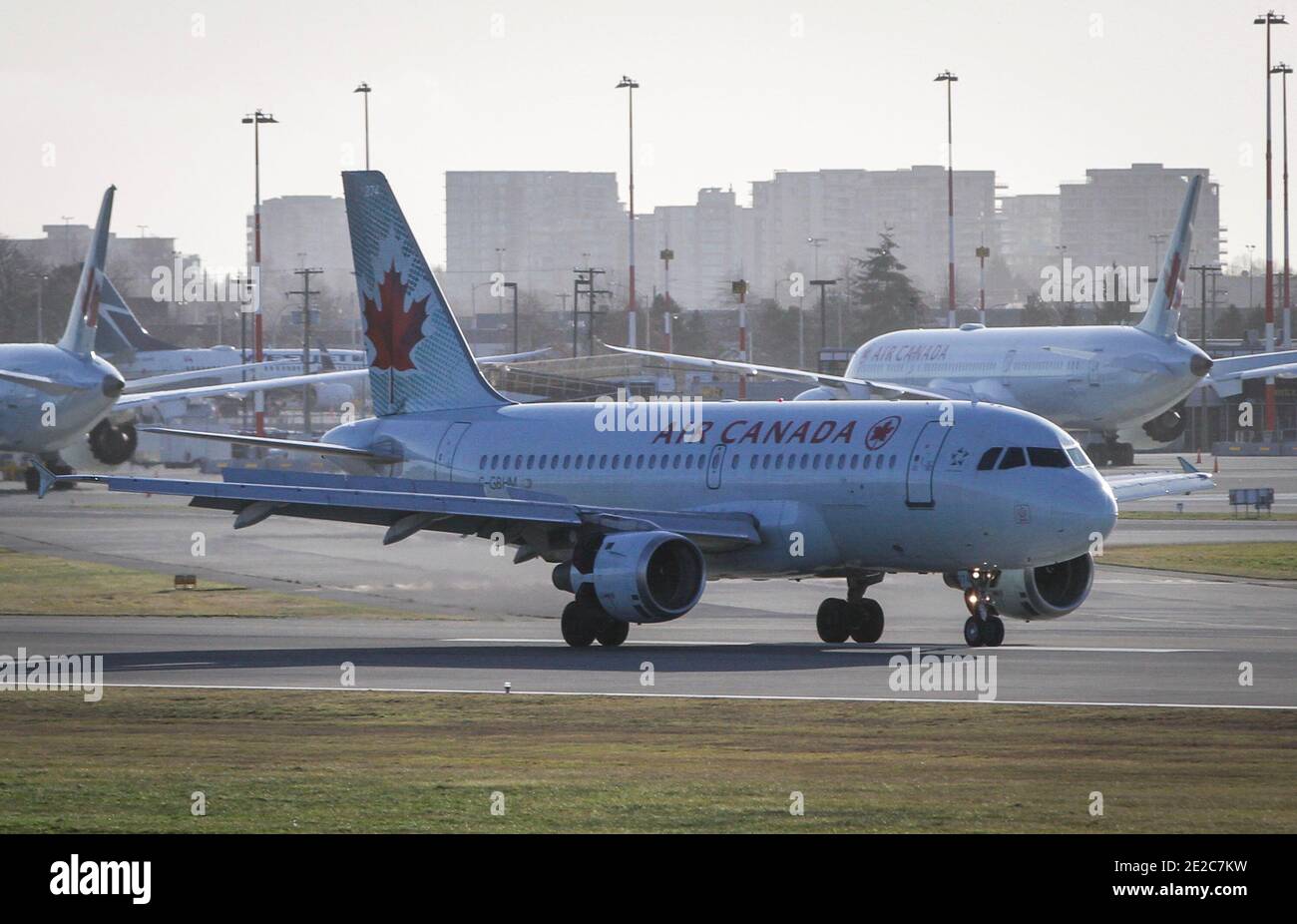 Richmond, Canada. 13th Jan, 2021. Air Canada aircrafts are seen on the runway of Vancouver International Airport in Richmond, British Columbia, Canada, Jan. 13, 2021. Air Canada announced on Wednesday that it is laying off about 1,700 employees due to official travel restrictions against the rampaging COVID-19 pandemic. Credit: Liang Sen/Xinhua/Alamy Live News Stock Photo
