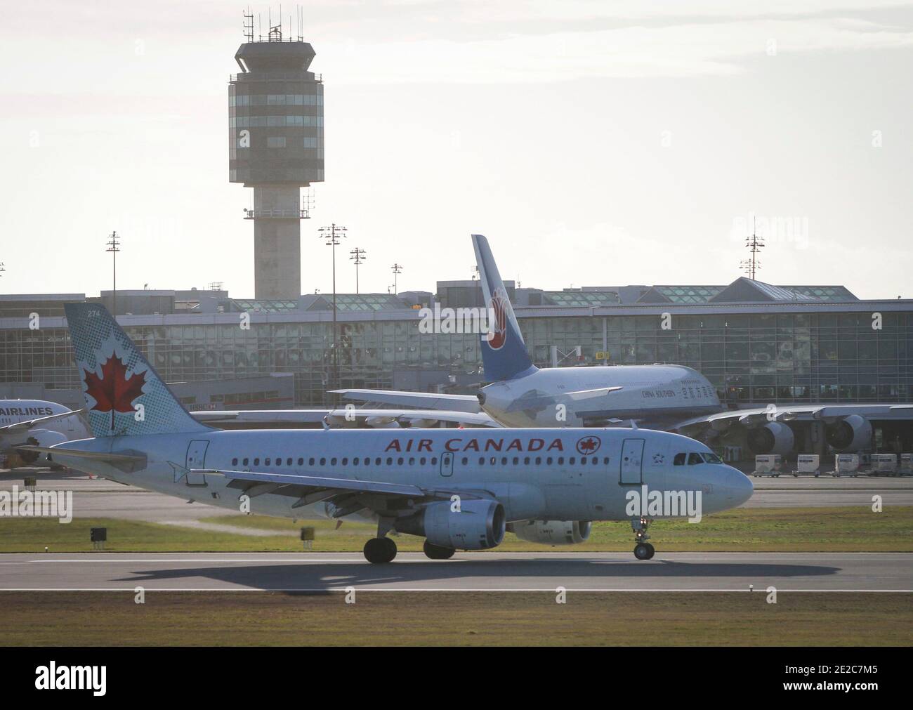 Richmond, Canada. 13th Jan, 2021. An air Canada aircraft is seen on the runway of Vancouver International Airport in Richmond, British Columbia, Canada, Jan. 13, 2021. Air Canada announced on Wednesday that it is laying off about 1,700 employees due to official travel restrictions against the rampaging COVID-19 pandemic. Credit: Liang Sen/Xinhua/Alamy Live News Stock Photo
