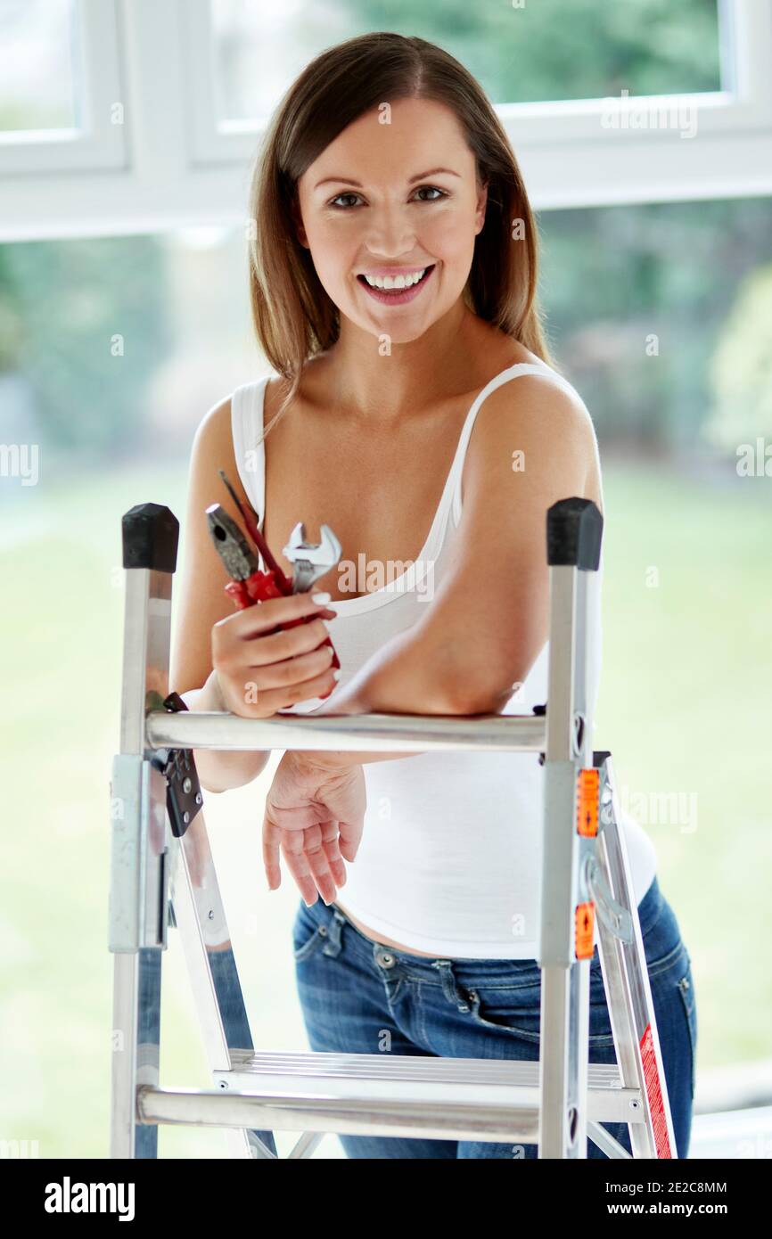 Woman at home doing DIY Stock Photo