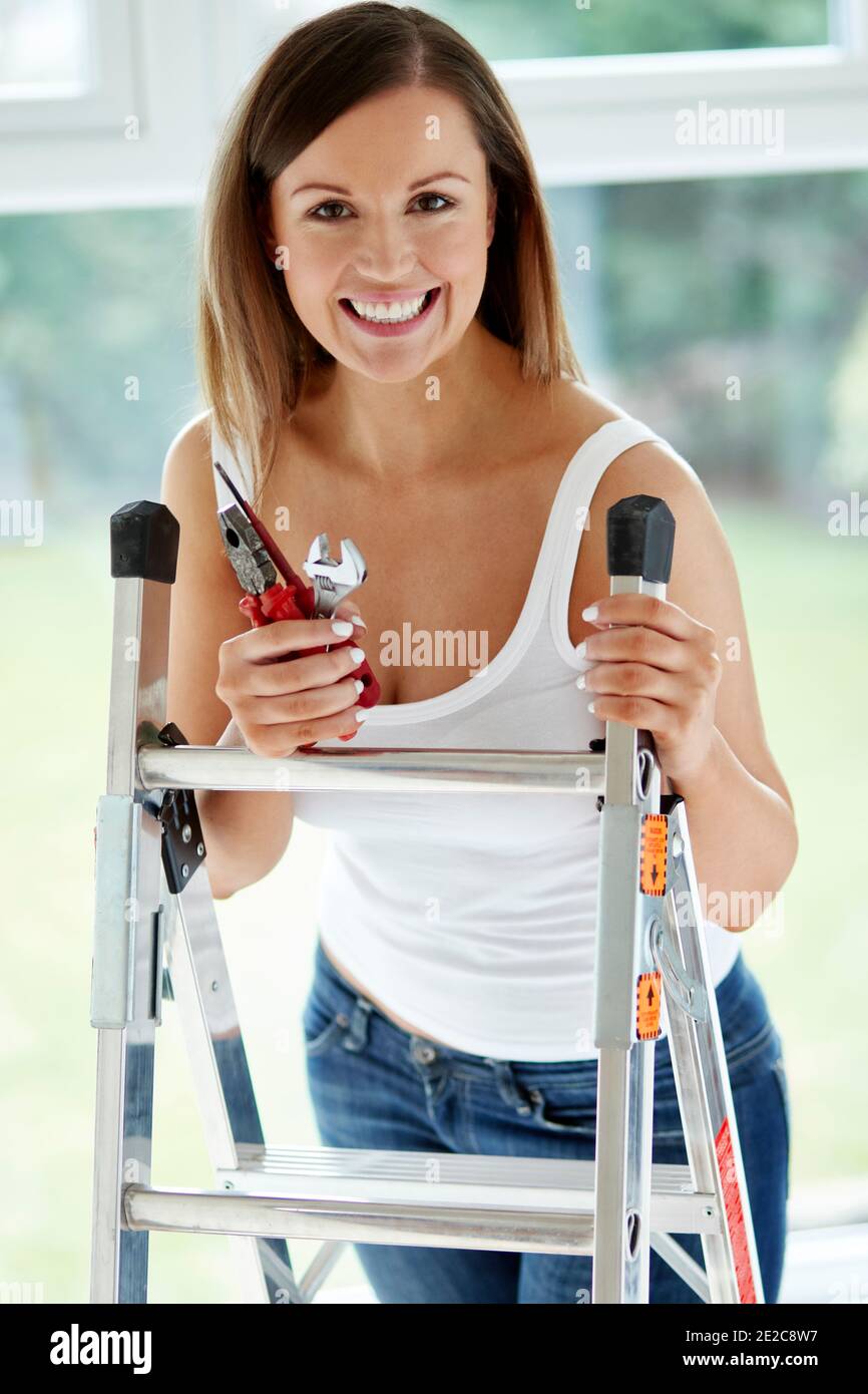 Woman at home doing DIY Stock Photo