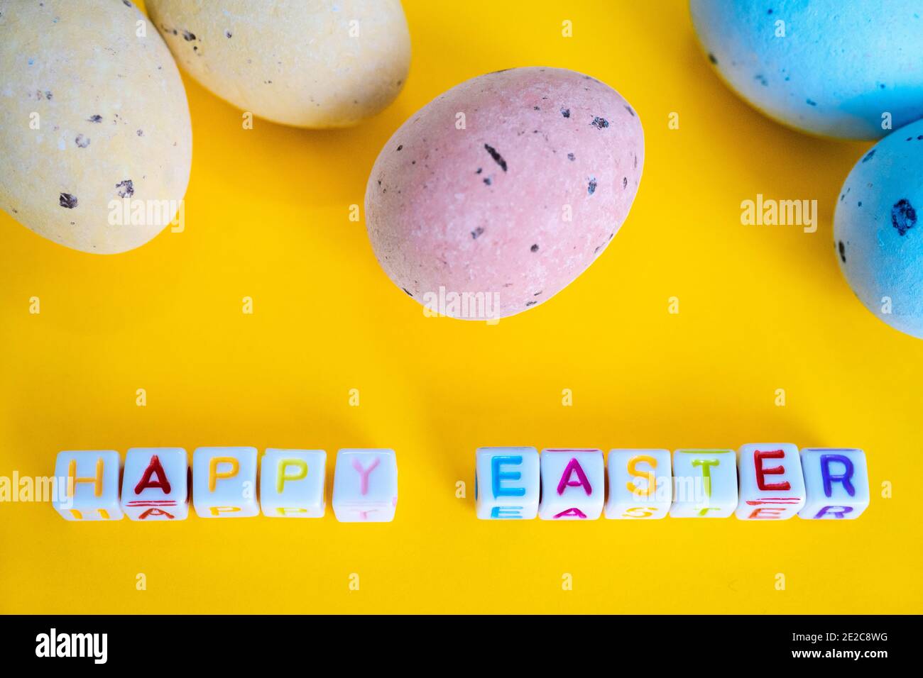 Easter greeting card with painted eggs. Seasonal Easter message Happy easter. Pastel and colorful decorated easter eggs with greeting card with text on yellow background. Spring holidays concept Stock Photo - Alamy