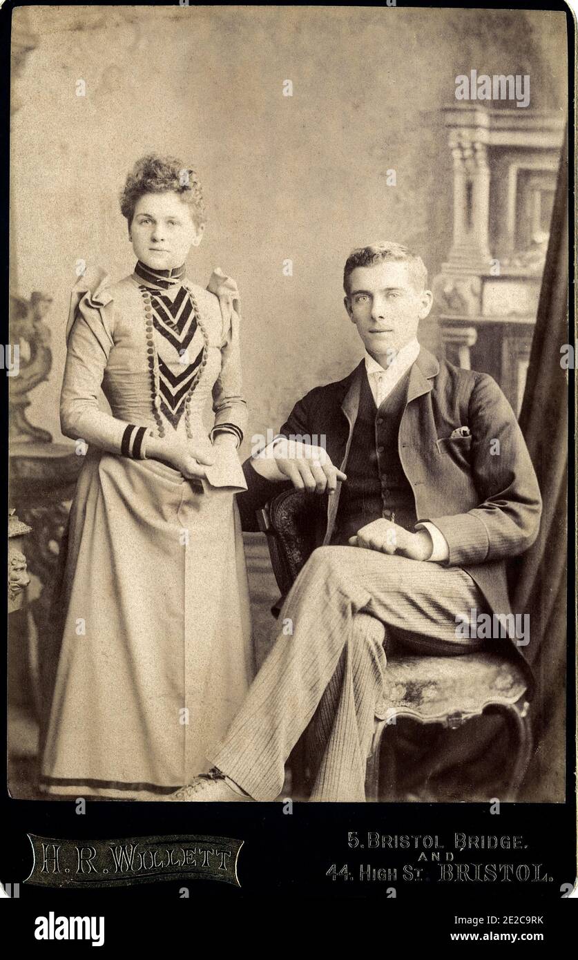 Victorian portrait of a fashionable young couple who have received an important letter that seems to be good news.  Taken c1897 in Bristol by H Willetts Stock Photo
