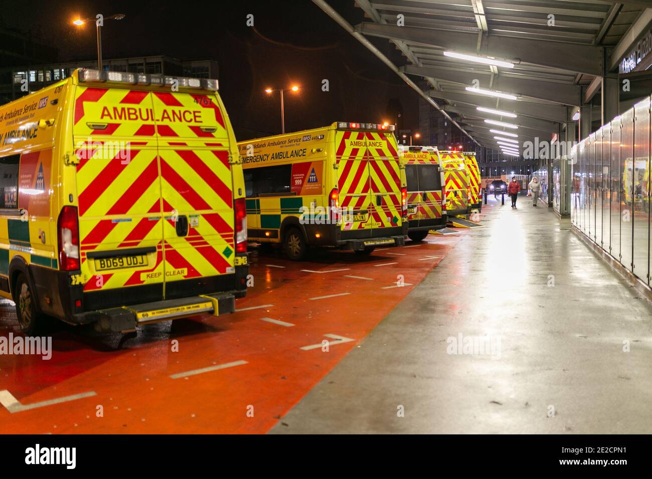 Selly Oak, Birmingham, UK. Ambulances line up outside the Queen Elizabeth Hospital in Birmingham in the evening on a day when the UK reports the highest increase in Covid 19 deaths. Credit: Peter Lopeman/Alamy Live News Stock Photo