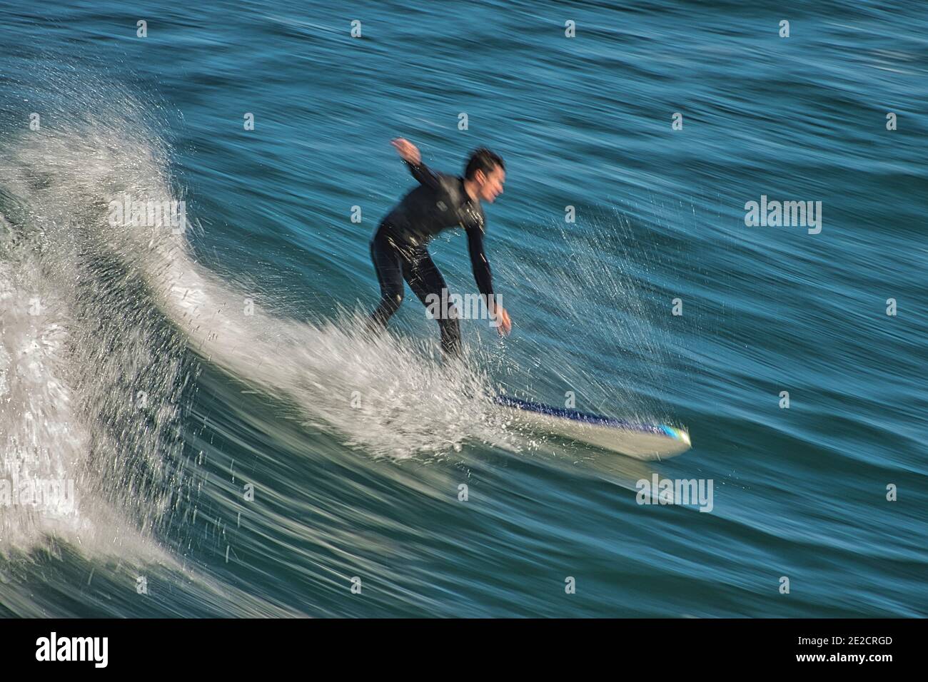 Surfer body boarding on the Monterey bay at Pacific Grove, California