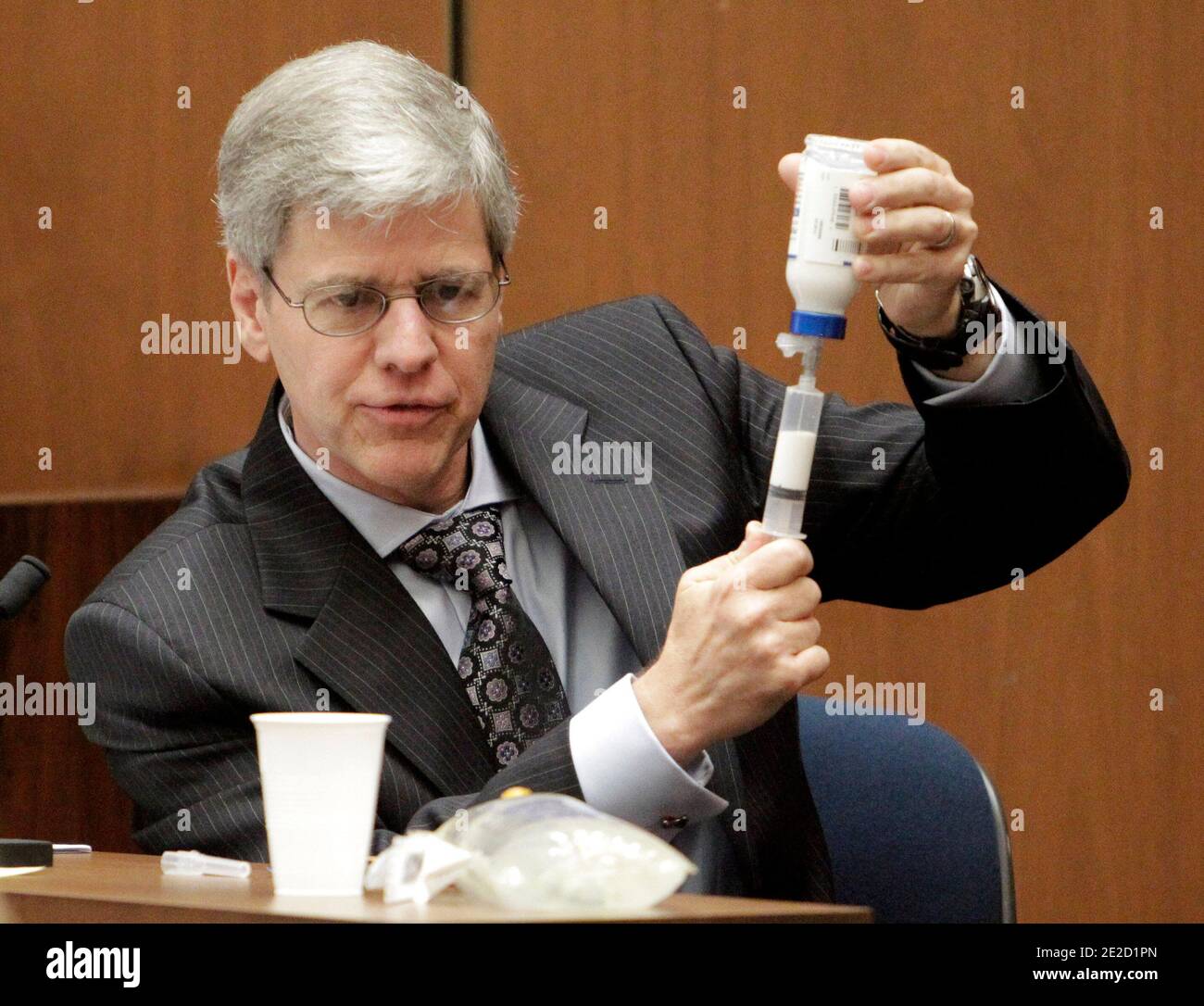 Anesthesiology expert Dr. Steven Shafer demonstrates how Propofol is extracted out of a glass bottle with a syringe during Dr. Conrad Murray's involuntary manslaughter trial in downtown Los Angeles on October 19, 2011. Murray has pleaded not guilty and faces four years in prison and the loss of his medical license if convicted of involuntary manslaughter in Michael Jackson's death. Photo by Reed Saxon/Pool/ABACAPRESS.COM Stock Photo