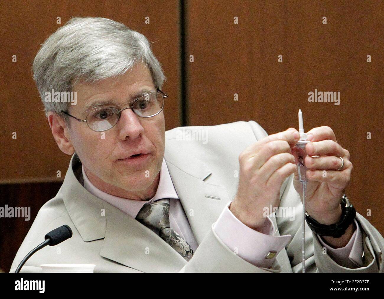 Anesthesiology expert Dr. Steven Shafer holds an intravenous line as he is cross examined by Ed Chernoff, a defense attorney for Dr. Conrad Murray, background right, during Murray's involuntary manslaughter trial in Los Angeles, CA, USA, on October 21, 2011. Murray has pleaded not guilty and faces four years in prison and the loss of his medical license if convicted of involuntary manslaughter in Michael Jackson's death. Photo by Reed Saxon/Pool/ABACAPRESS.COM Stock Photo