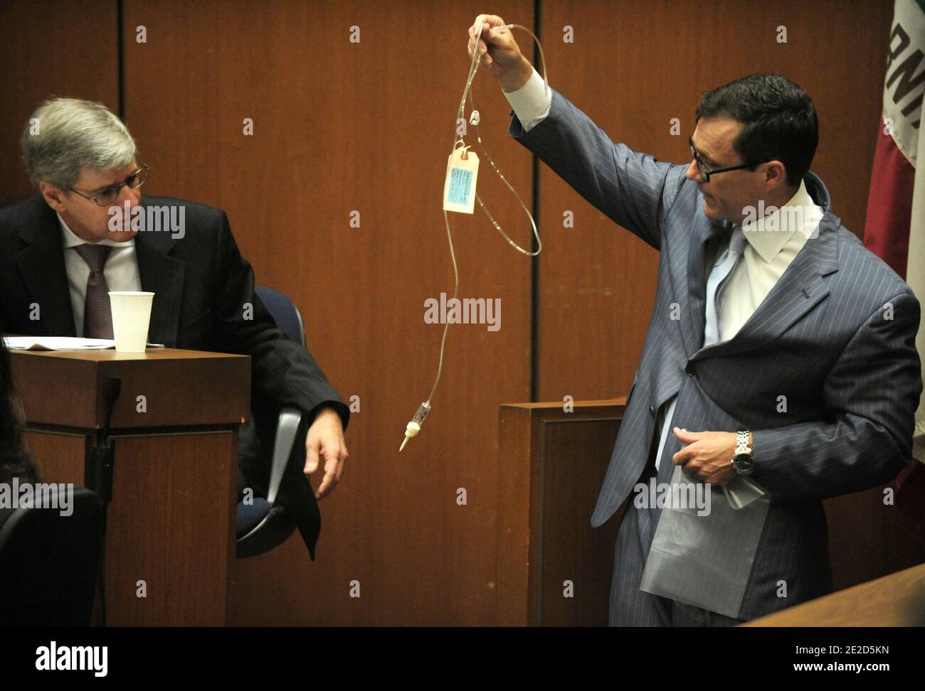 Defense attorney Ed Chernoff (R) holds up an intravenous drip (IV ...
