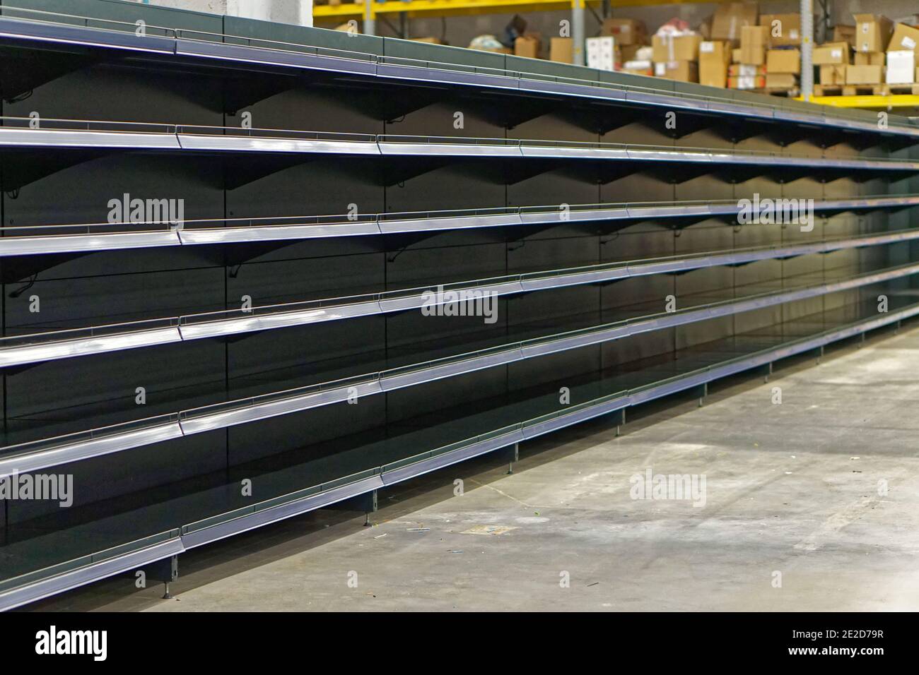 Empty long shelf in grocery store food shortages problems Stock Photo