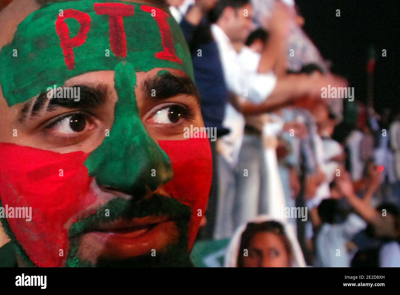 Supporter of Pakistani politician and former cricketer Imran Khan participates in a rally in Lahore, Pakistan on October 30, 2011. A crowd of thousands gathered called by Khan to press President Asif Ali Zardari to step down. The rally, seen as a show of strength, comes two days after Sharif's brother Shahbaz, attracted some 30,000 people at an anti-Zardari protest also in the key political battleground of Lahore. Photo by Irfan/ABACAPRESS.COM Stock Photo