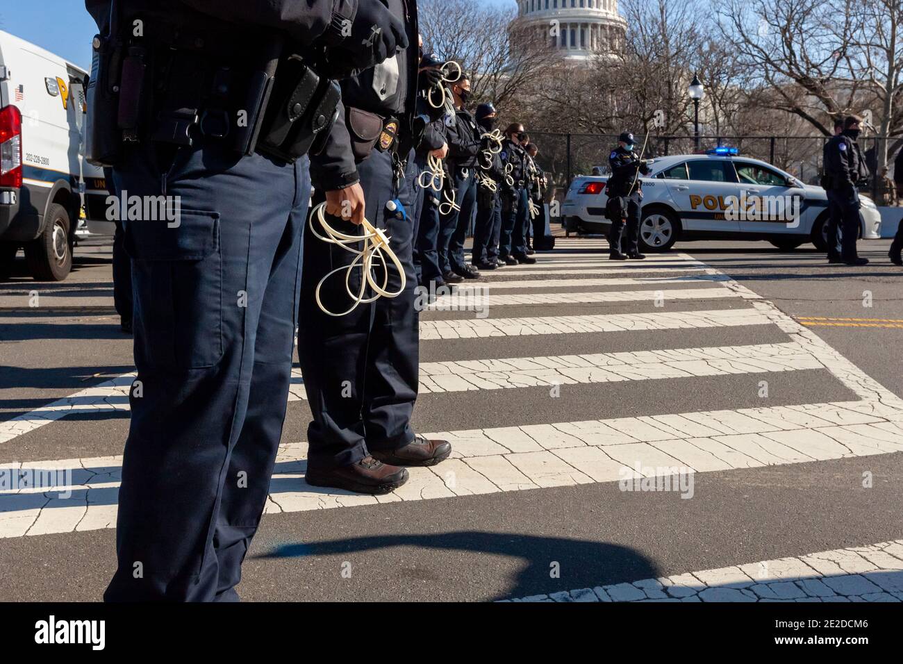 Washington, DC, USA, 13 January, 2021.  Pictured: Capitol Police greeted participants with large numbers of officers and plastic handcuffs at Shutdown DC's Expel All Fascists protest.  This was in stark contrast to the welcome given terrorists and insurrectionists the previous week.  Protesters wrote the names of Representatives and Senators who objected to certification of the presidential election results on January 6 on three large banners.  The banners called expulsion of all fascists from Congress.  Credit: Allison C Bailey/Alamy Live News Stock Photo
