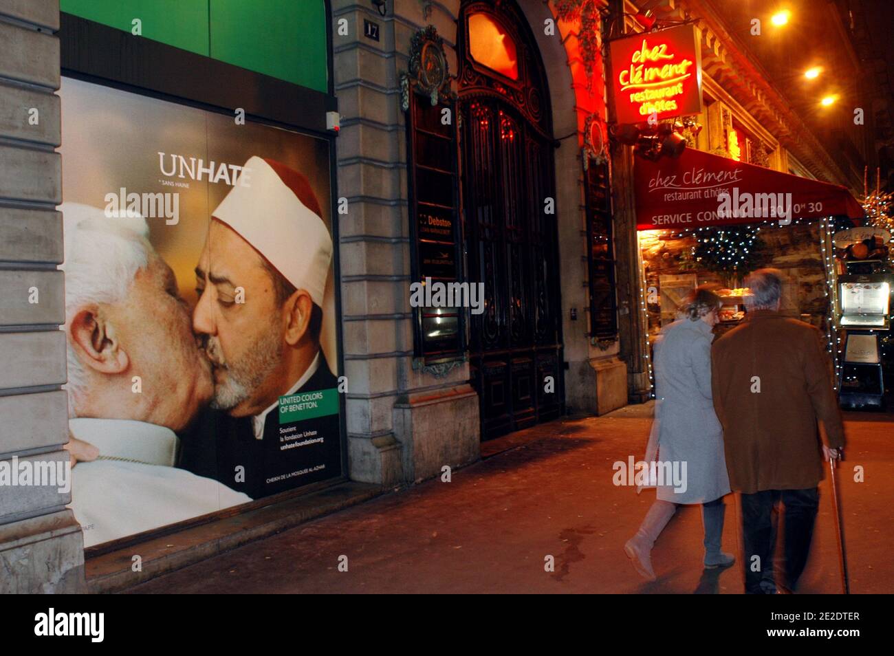 Posters from new Benetton's ad campaign 'Unhate' are on display on it's  flagship store windows, Place de l'Opera in Paris, France, November 16,  2011. They show various pictures of political opponents kissing.