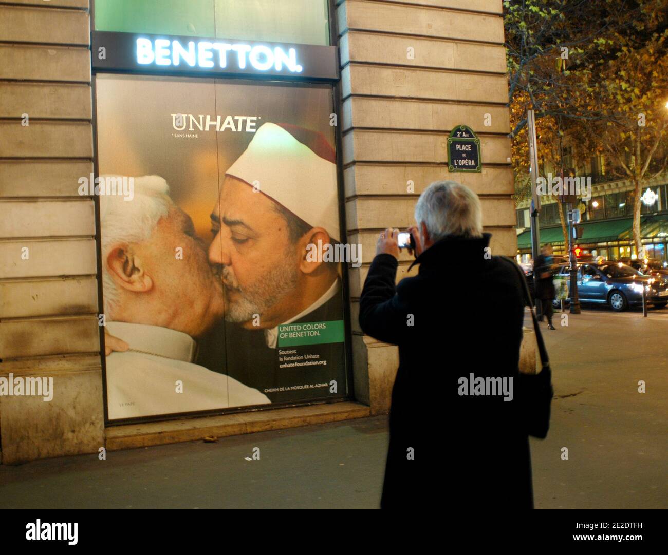 Posters from new Benetton's ad campaign 'Unhate' are on display on it's flagship store windows, Place de l'Opera in Paris, France, November 16, 2011. They show various pictures of political opponents kissing. They included Barack Obama and Venezualan leader Hugo Chavez, German Chancellor Angela Merkel and French President Nicolas Sarkozy, and the Israeli and Palestinian leaders Benjamin Netanyahu and Mahmoud Abbas. The company said the adverts were aimed at fostering tolerance and 'global love' but it prompted a quick reaction from the Vatican. Benetton has been forced to pull a picture of Pop Stock Photo