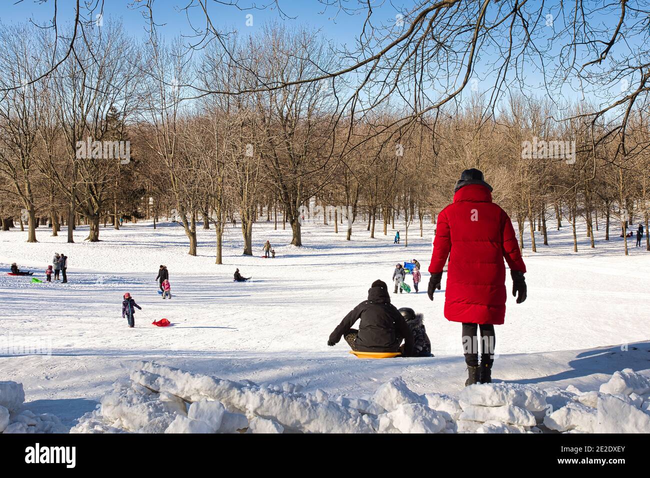 January 09, 2021 - Montreal, Canada People doing winter sliding in park Mont-Royal during daytime Stock Photo