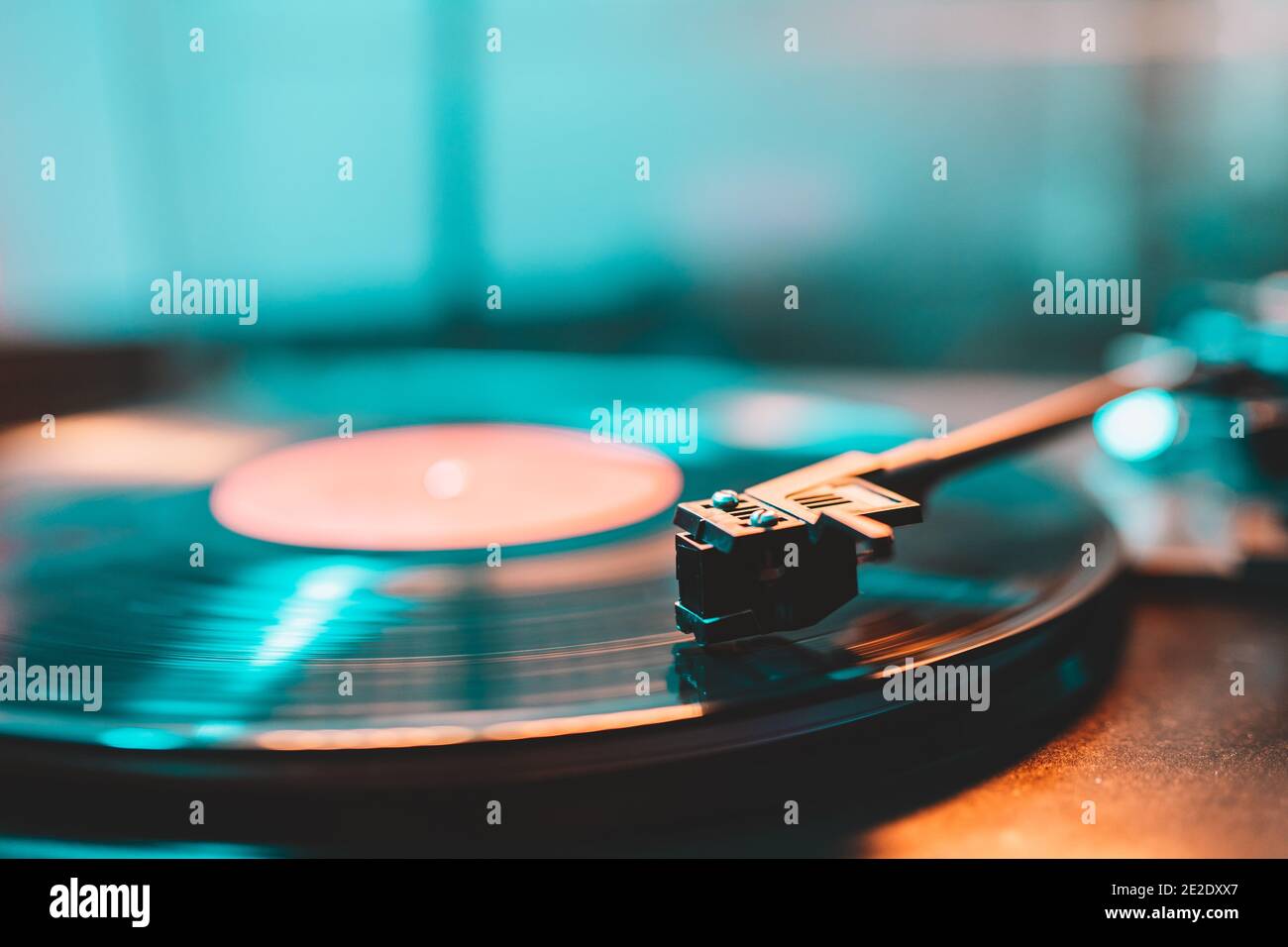 Cinemagraph loop vinyl record player turntable with its stylus running along music plate. Neon