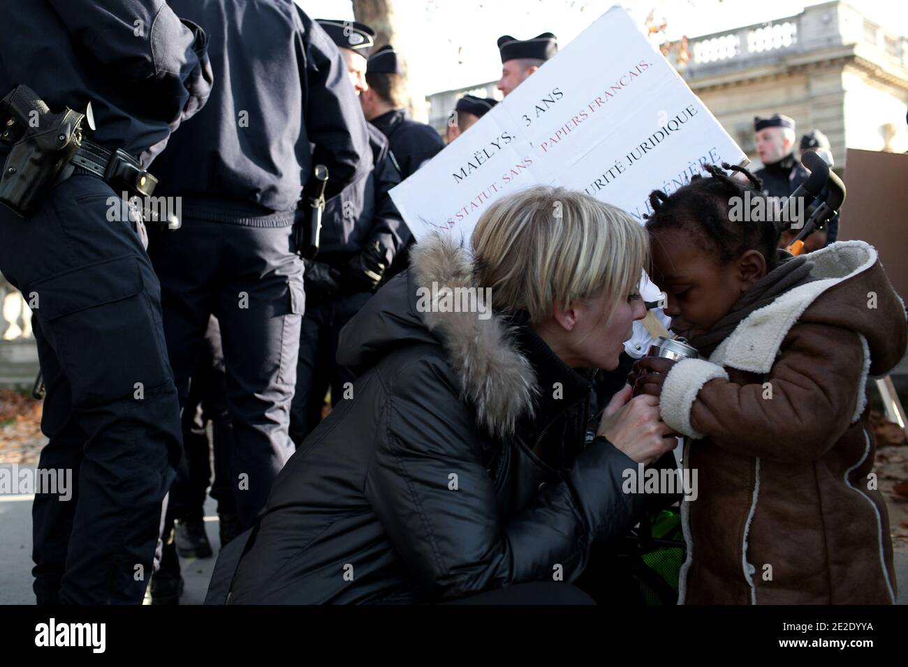 French parents with adopted Haitian children take part in a demonstration in front of France's Foreign Affairs ministry in Paris, France, on November 19, 2011 to ask French authorities to give a legal statute for the little survivors of the Haiti quake they adopted. On the picture, a child tries to give to the authorities a doll. Photo by Stephane Lemouton/ABACAPRESS.COM Stock Photo