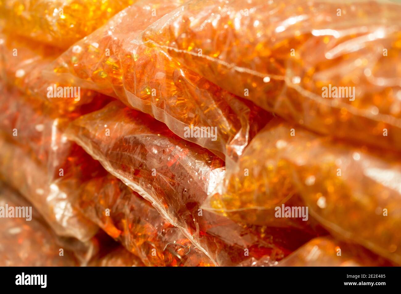 Stacks of orange crystals and pearls packages for bijou Stock Photo