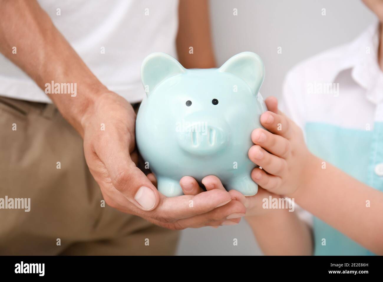 Family piggy bank hands hi-res stock photography and images - Alamy