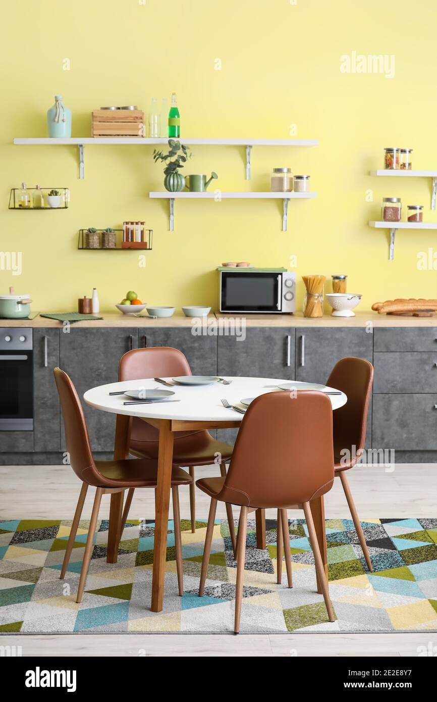 Dining table and chairs in interior of modern kitchen Stock Photo - Alamy