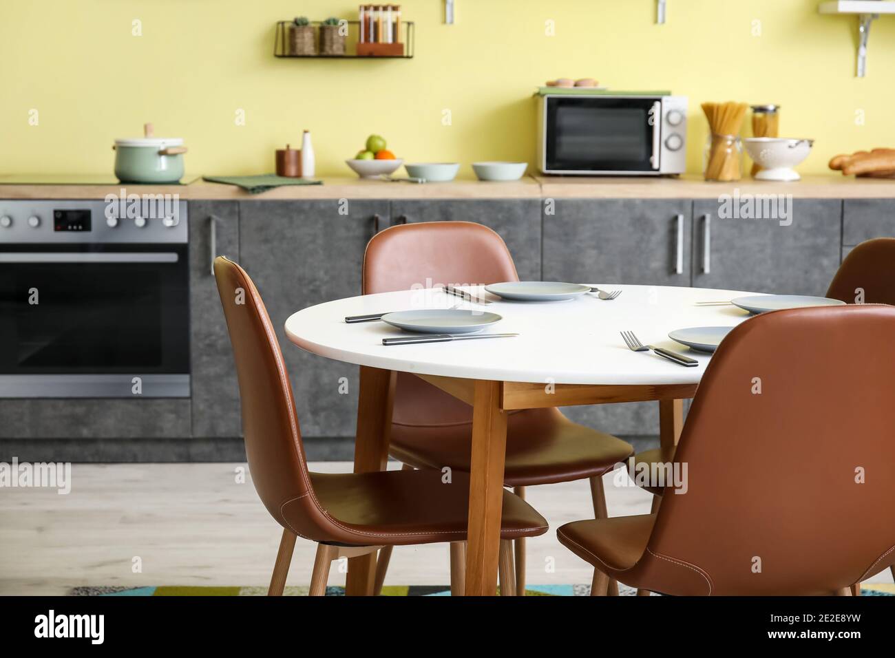 Dining table and chairs in interior of modern kitchen Stock Photo - Alamy
