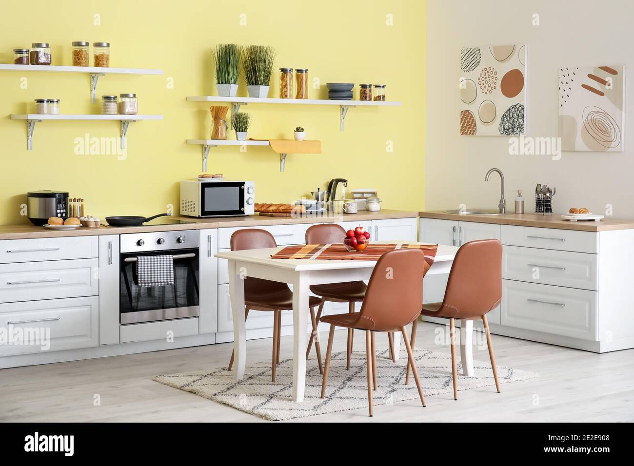 Interior of modern kitchen with dining table and chairs Stock Photo - Alamy