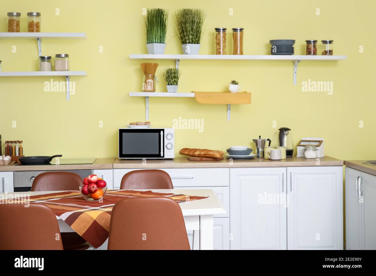 Interior of modern kitchen with dining table and chairs Stock Photo - Alamy
