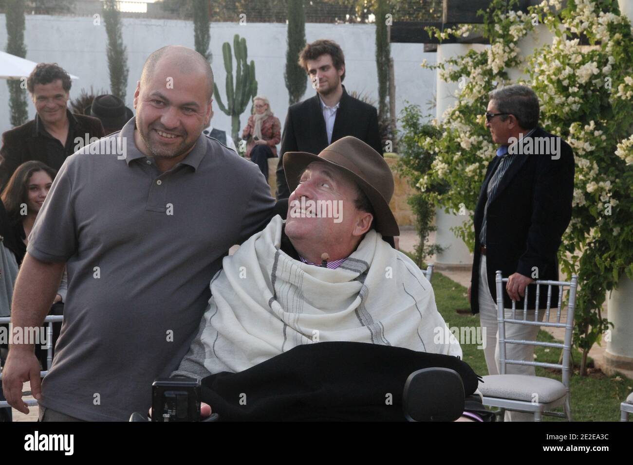 EXCLUSIVE - Philippe Pozzo di Borgo, who became quadriplegic after a paragliding accident in 1993, poses with his former auxiliary Abdel Seliou in Marakkech, Morocco, November 13, 2011. His story inspired the movie 'Intouchables' directed by Olivier Nakache and Eric Toledano, released in France on November 2011, in which the actor Francois Cluzet plays his role and actor Omar Sy plays Abdel Seliou's role. In France, the movie reached 10 million of filmgoers. Photo by William Stevens/ABACAPRESS.COM Stock Photo