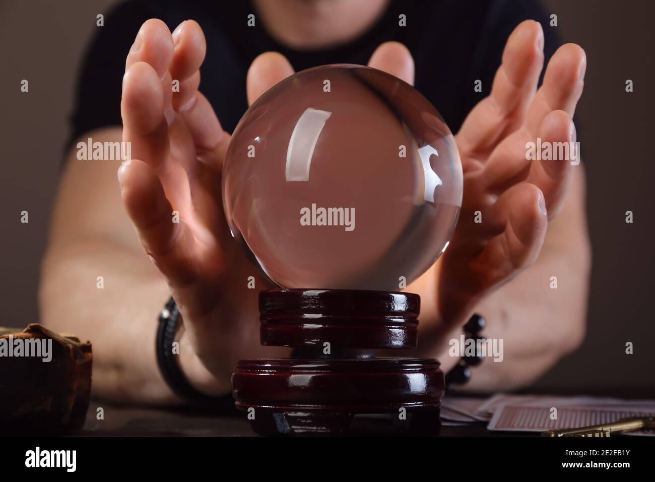 Fortune teller with crystal ball reading future at table Stock Photo