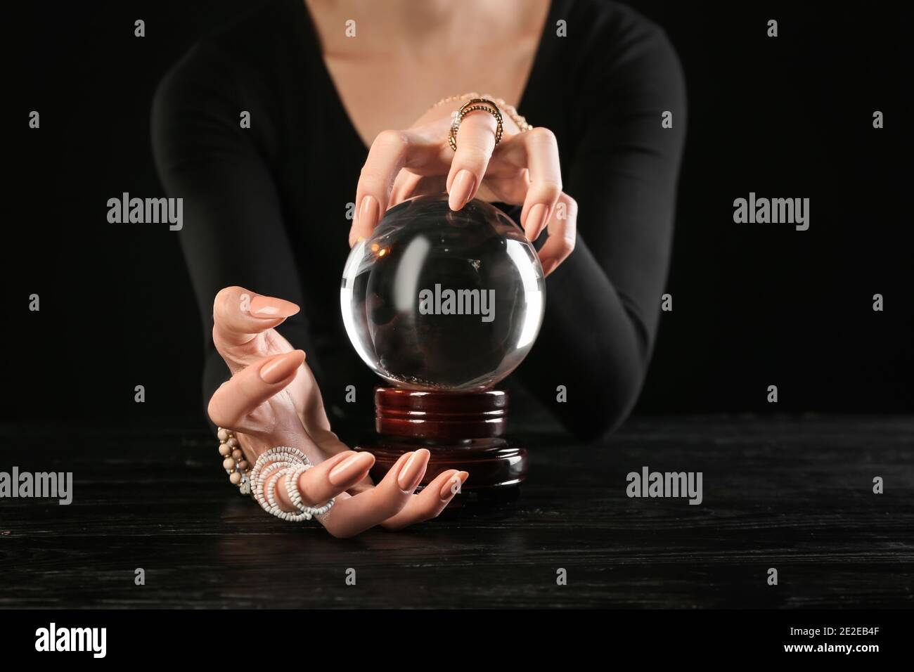 Fortune teller with crystal ball at table Stock Photo Alamy