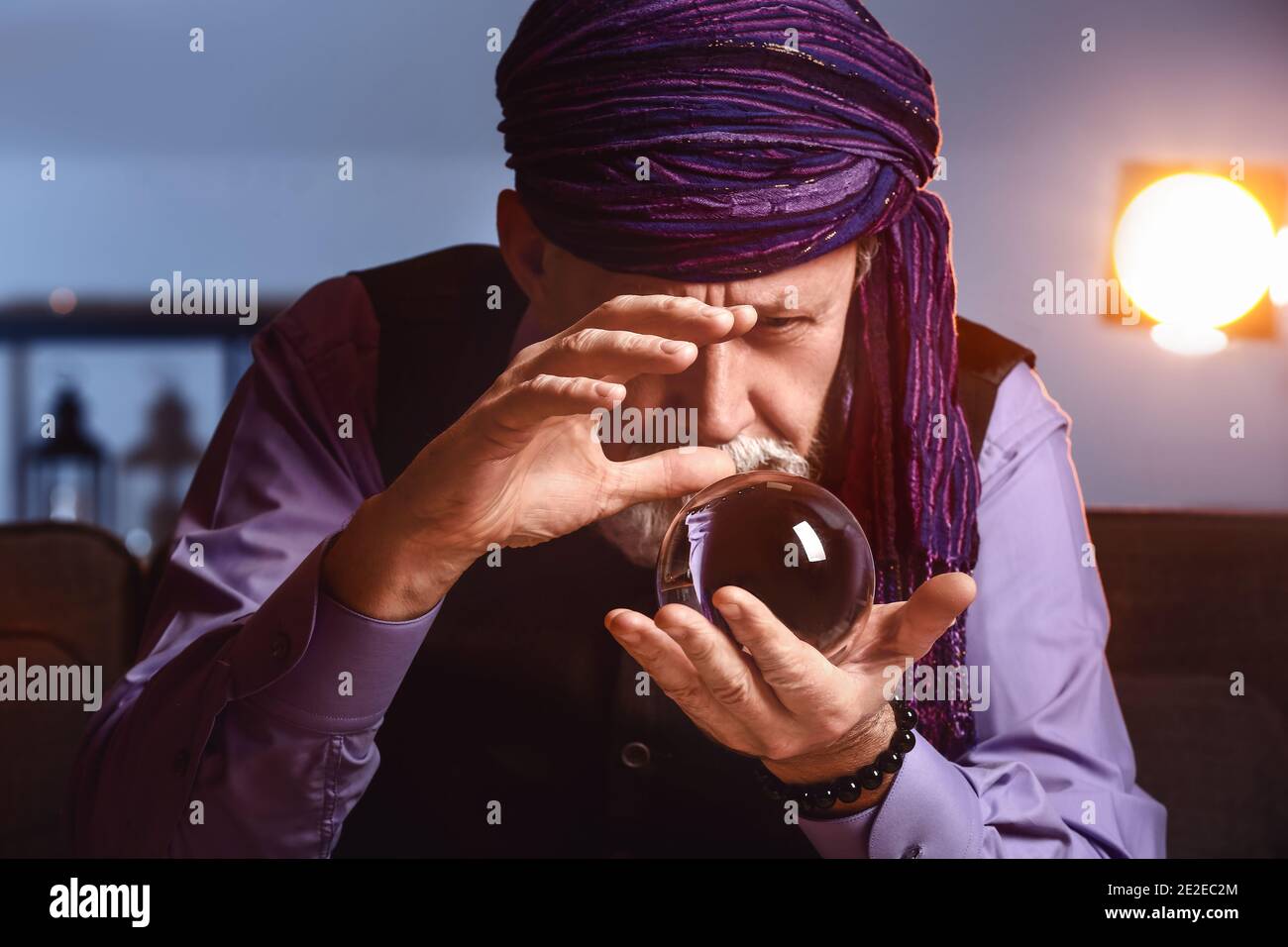 Male fortune teller with crystal ball at home Stock Photo Alamy