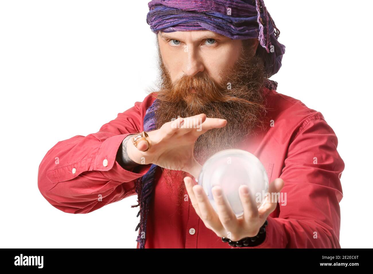 Male fortune teller with crystal ball on white background Stock Photo