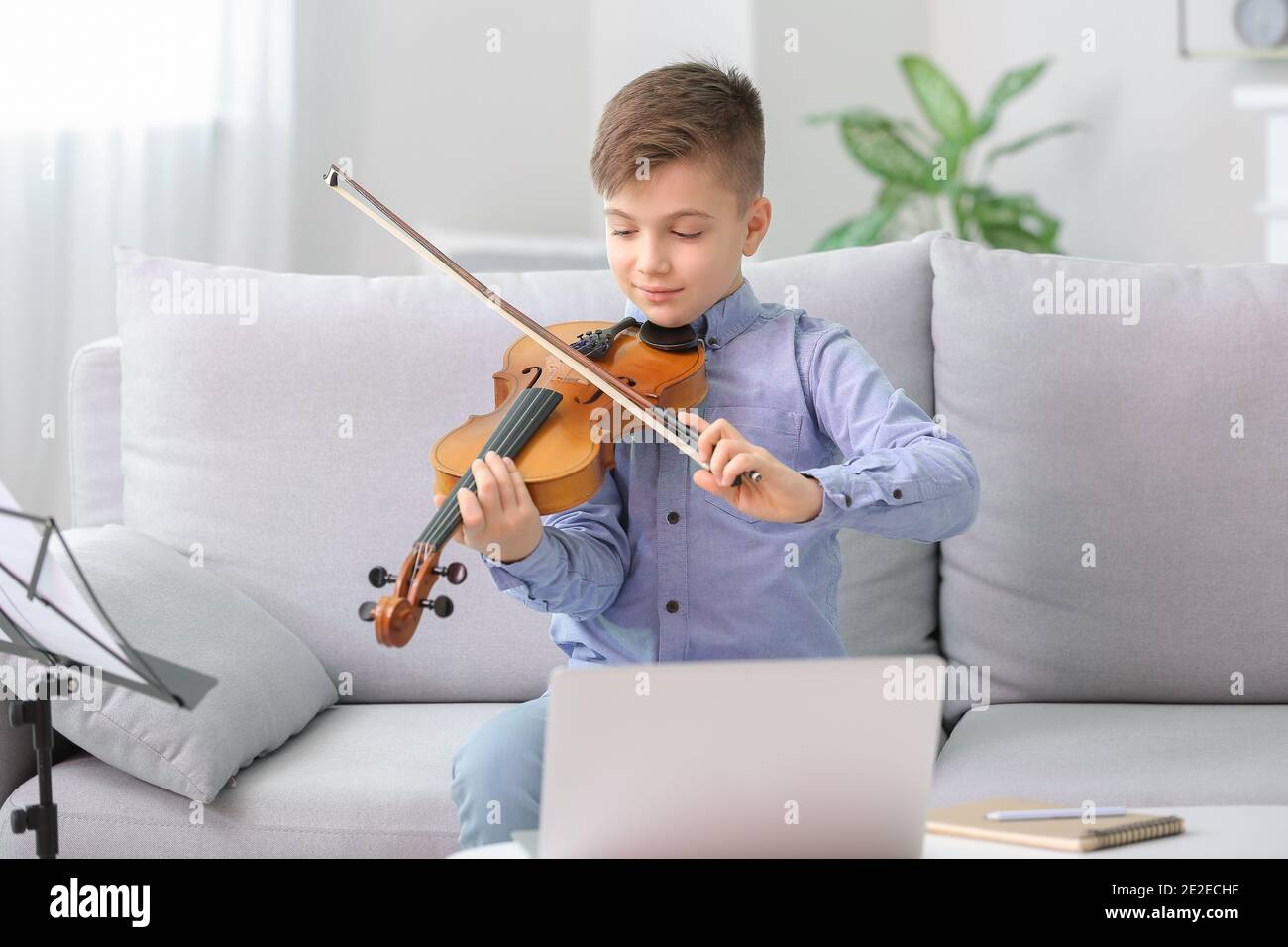 Little boy taking music lessons online at home Stock Photo - Alamy