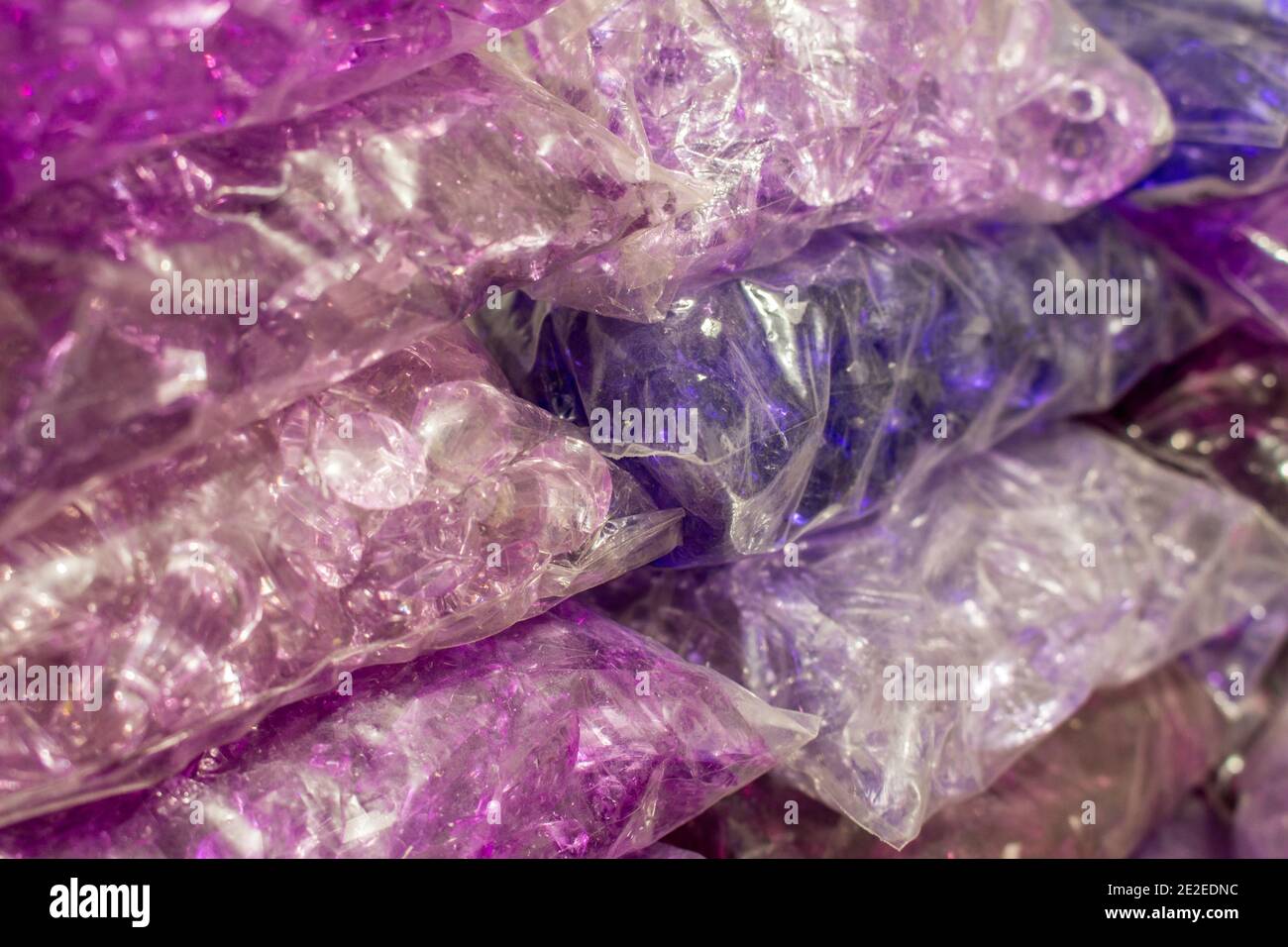 Stacks of purple crystals and pearls packages for bijou Stock Photo