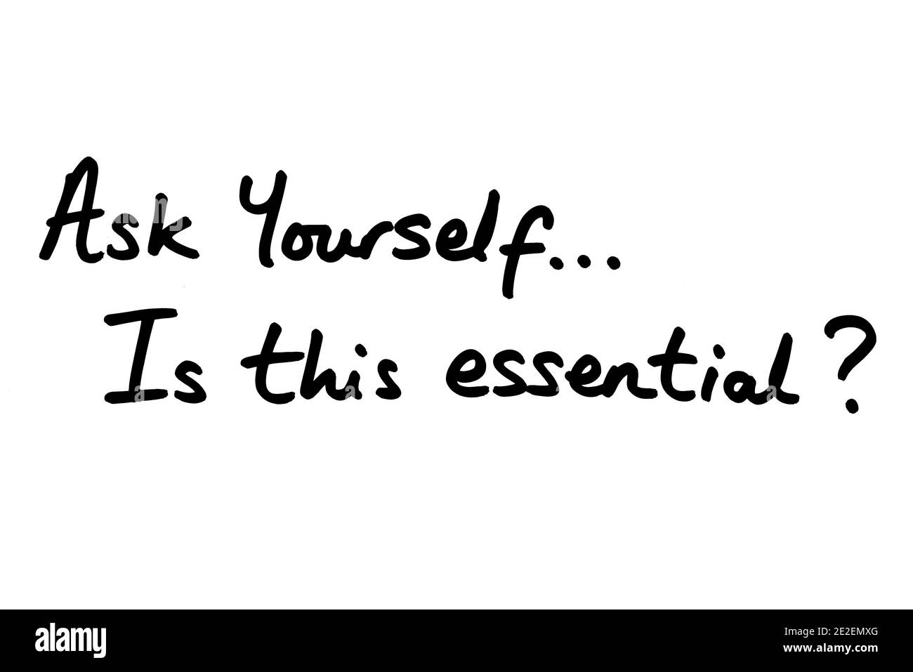 Ask Yourself..is this essential? handwritten on a white background. Stock Photo