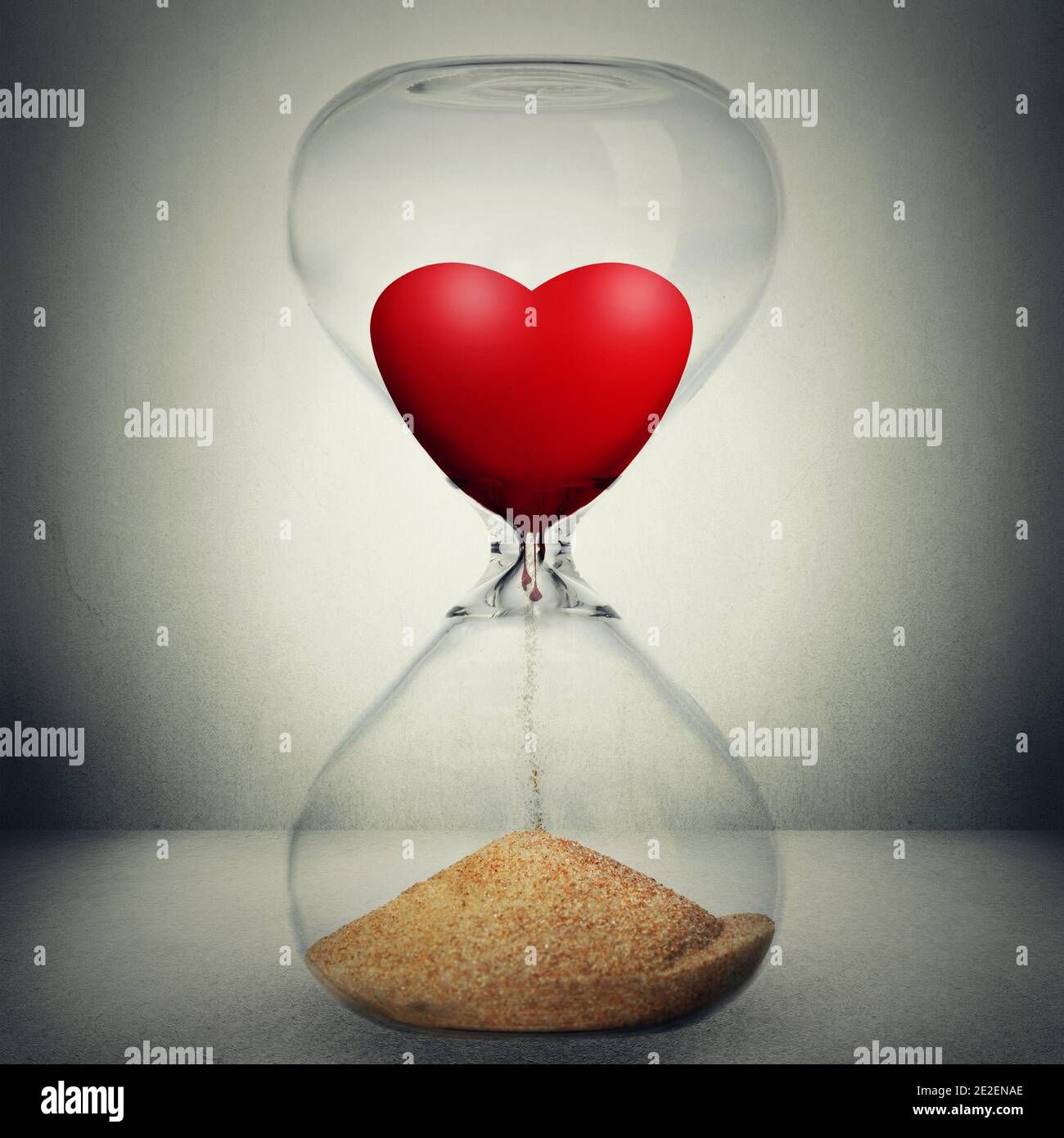 Even love is not eternal concept. Love is temporary conceptual photo manipulation. Closeup of hourglass with heart inside pouring down transforming in Stock Photo