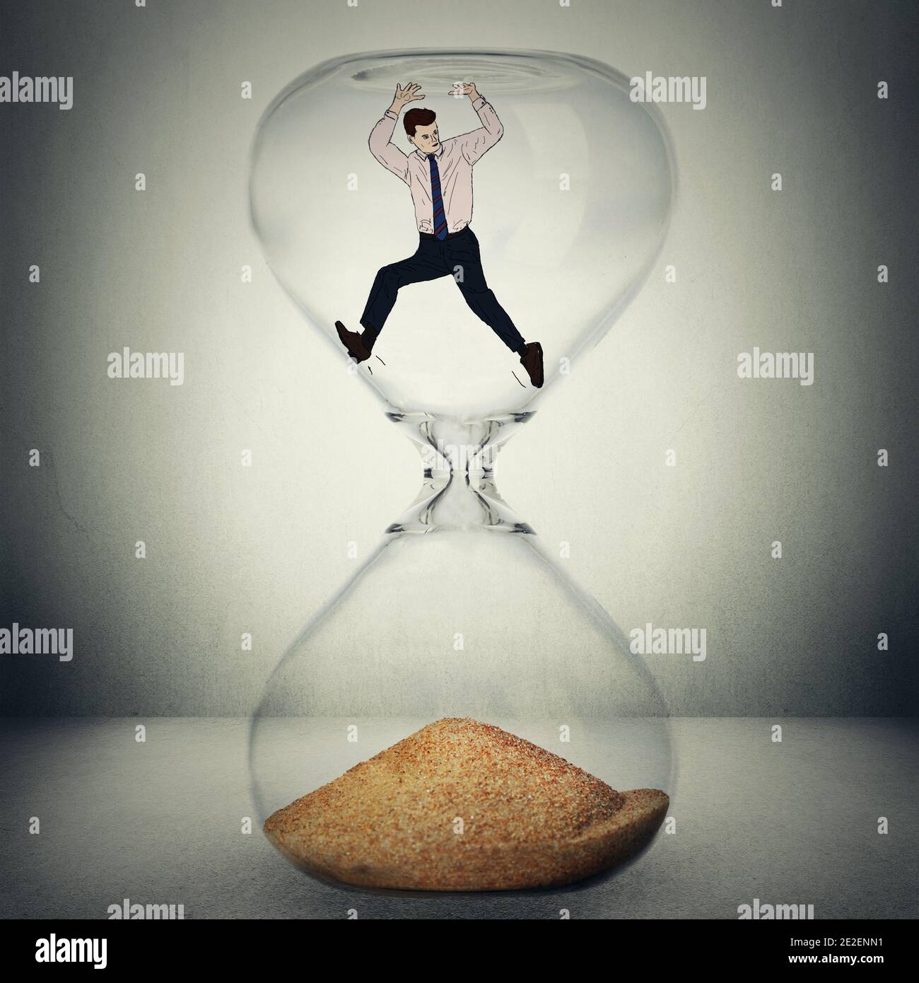 Time is ticking concept. Everything is temporary, nothing is eternal conceptual photo manipulation. Closeup of hourglass with man inside about to be w Stock Photo