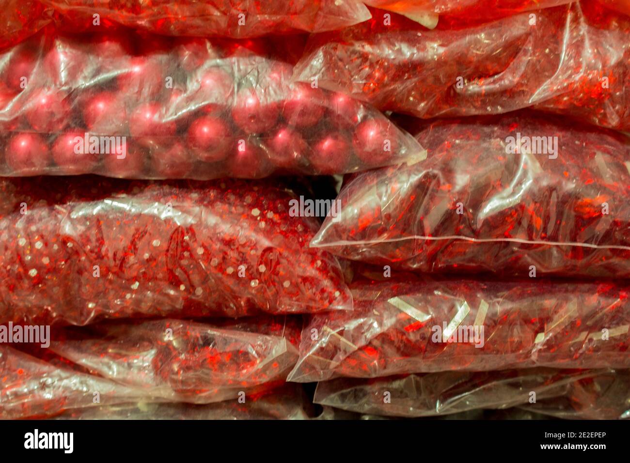Stacks of red crystals and pearls packages for bijou Stock Photo