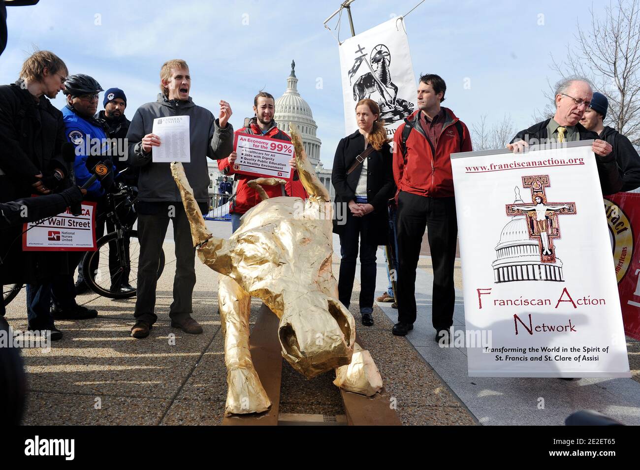 Occupy DC protesters and faith leaders march to the U.S. Capitol with a giant Golden Calf in the shape of the Wall Street Bull to call on Speaker Boehner to support taxes on Wall Street trades in Washington, DC, USA December 15, 2011. Photo by Olivier Douliery/ABACAPRESS.COM Stock Photo