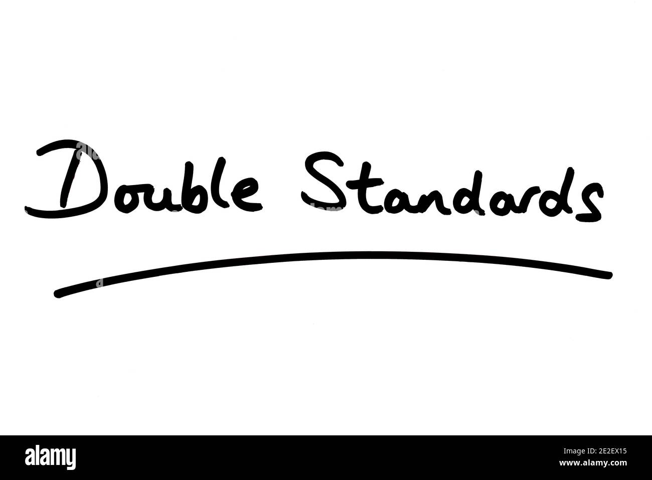 Double Standards handwritten on a white background. Stock Photo