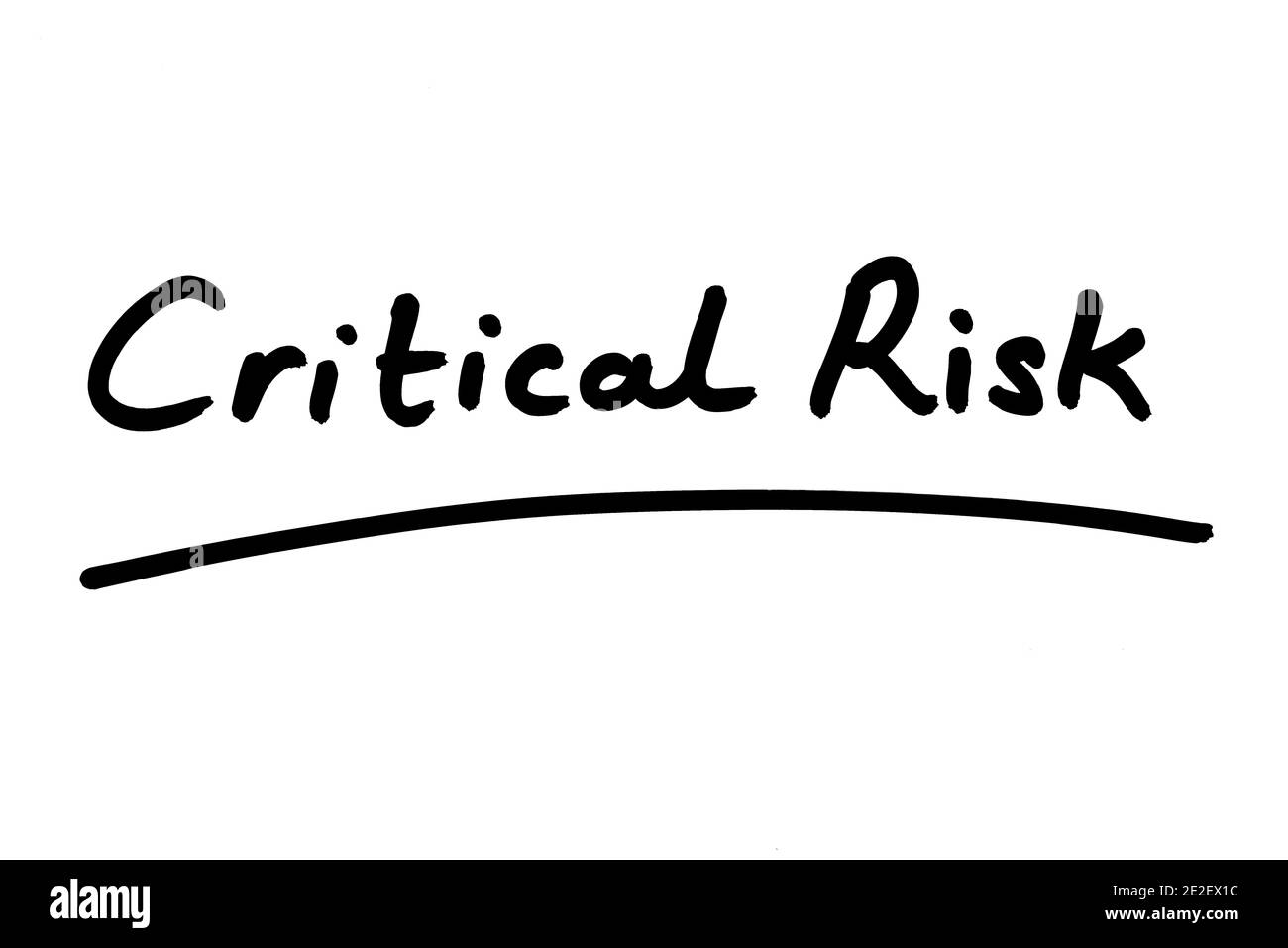 Critical Risk handwritten on a white background. Stock Photo