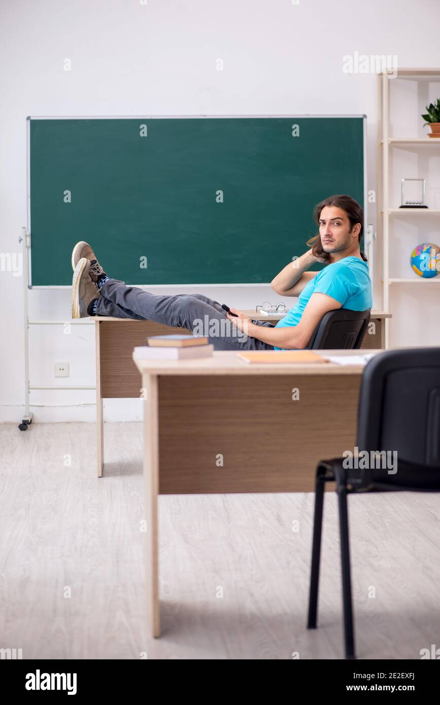 Front Student Young student in front of green board Stock Photo - Alamy