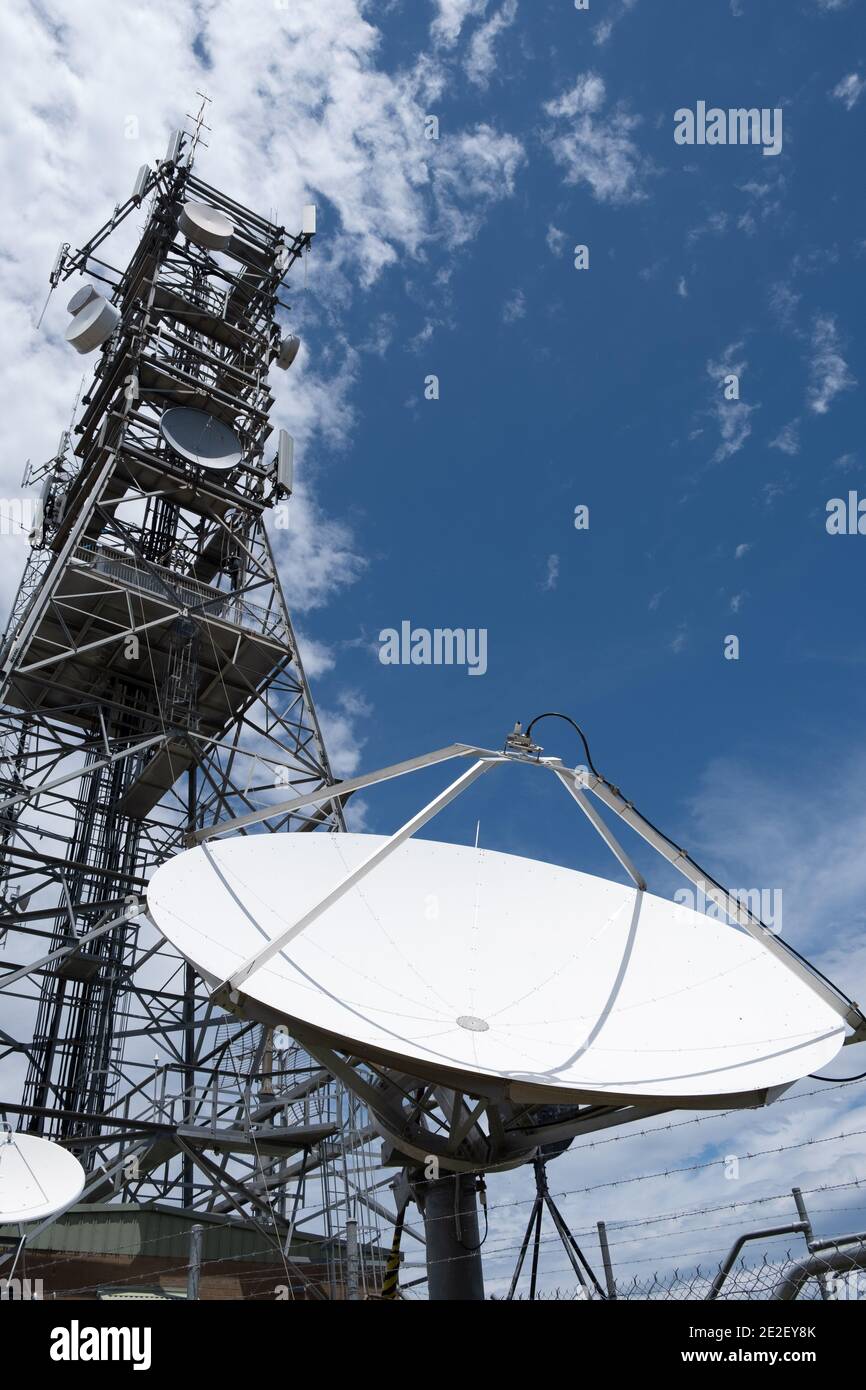 Dish antenna against blue sky - vertical image Stock Photo