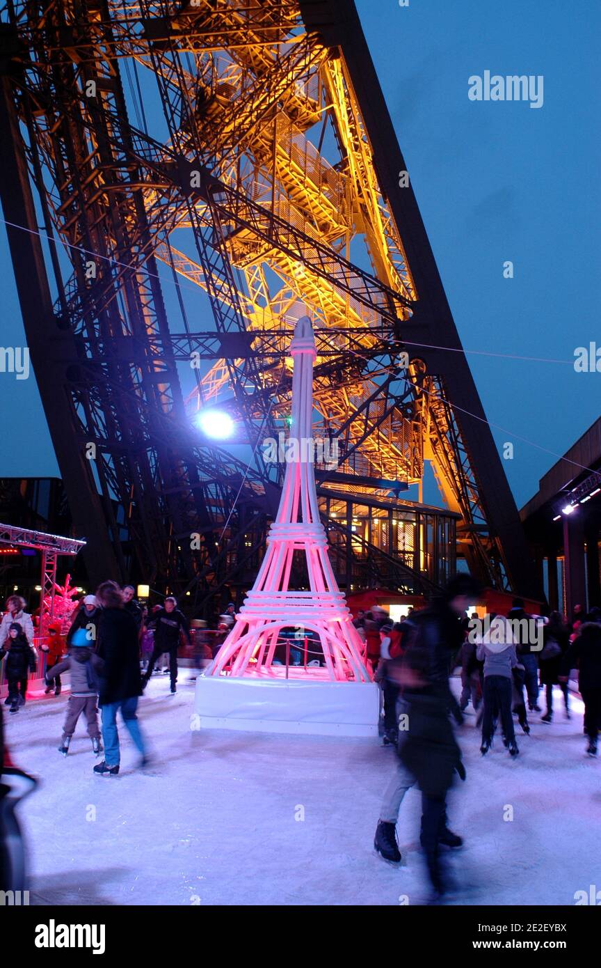 Skaters gliding along the ice on the first floor of the Eiffel Tower, 57 meters above ground level, on the first floor of the Eiffel Tower in Paris, France, December 20, 2011. The rink will only be in operation until February 1st. It is the second consecutive year that the ice skating rink opens in the Eiffel Tower. At 200 square meters (2,150 sq feet), it is only about a third of the size of New York's famed Rockefeller Center ice rink. Last year, more than 1,000 skaters visited the Tower's frozen surface, dubbed 'a popular success,' by organizers of the initiative. Skates can be hired for 5 Stock Photo