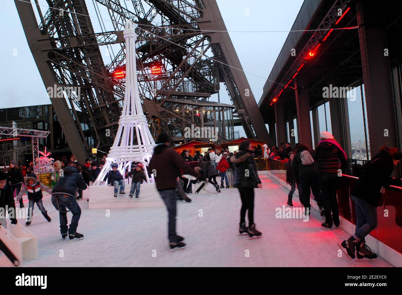 Skaters gliding along the ice on the first floor of the Eiffel Tower, 57 meters above ground level, on the first floor of the Eiffel Tower in Paris, France, December 20, 2011. The rink will only be in operation until February 1st. It is the second consecutive year that the ice skating rink opens in the Eiffel Tower. At 200 square meters (2,150 sq feet), it is only about a third of the size of New York's famed Rockefeller Center ice rink. Last year, more than 1,000 skaters visited the Tower's frozen surface, dubbed 'a popular success,' by organizers of the initiative. Skates can be hired for 5 Stock Photo