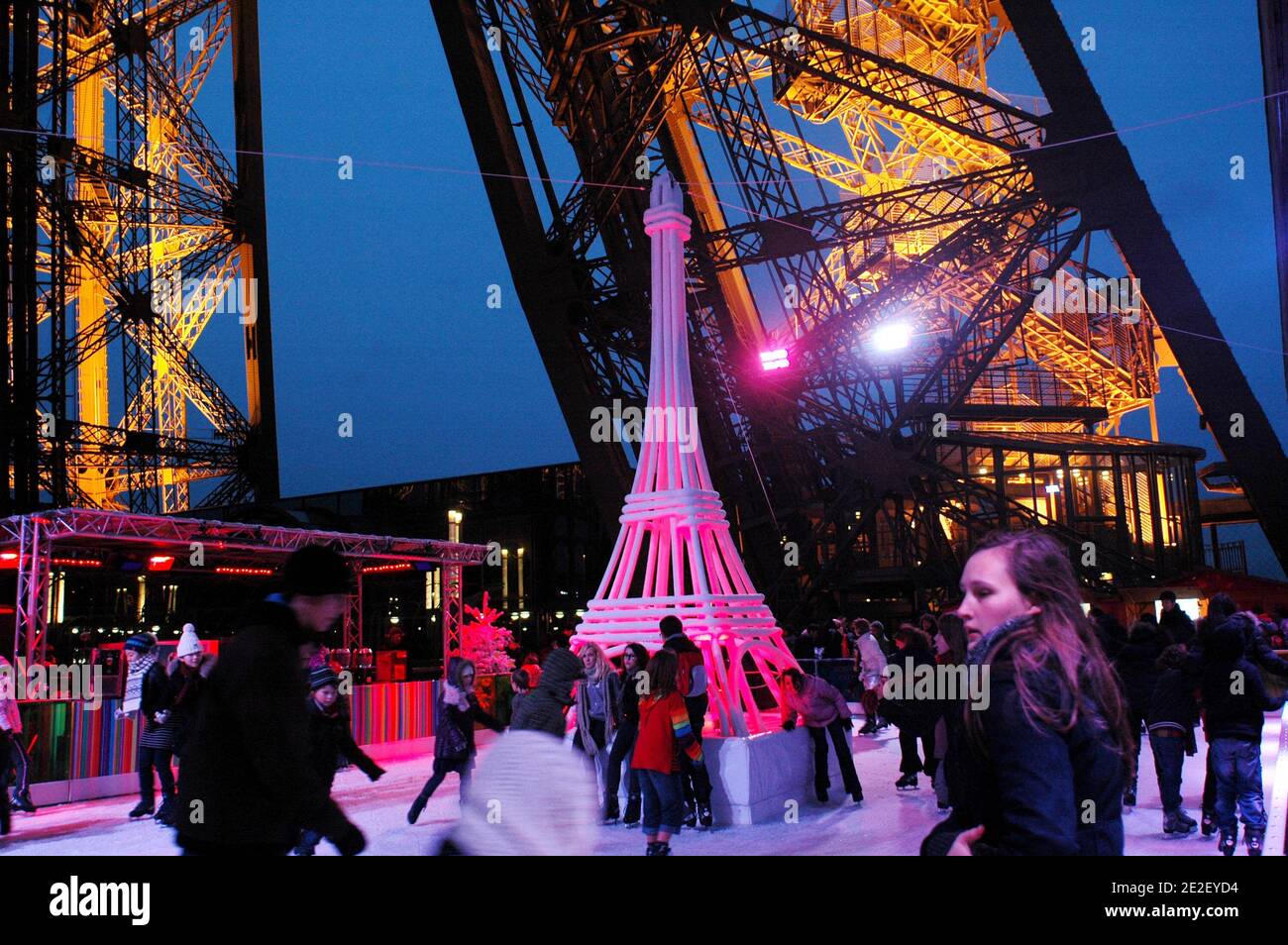 Skaters gliding along the ice on the first floor of the Eiffel Tower, 57 meters above ground level, on the first floor of the Eiffel Tower in Paris, France, December 20, 2011. The rink will only be in operation until February 1st. It is the second consecutive year that the ice skating rink opens in the Eiffel Tower. At 200 square meters (2,150 sq feet), it is only about a third of the size of New York's famed Rockefeller Center ice rink. Last year, more than 1,000 skaters visited the Tower's frozen surface, dubbed 'a popular success,' by organizers of the initiative. Skates can be hired for 5 Stock Photo