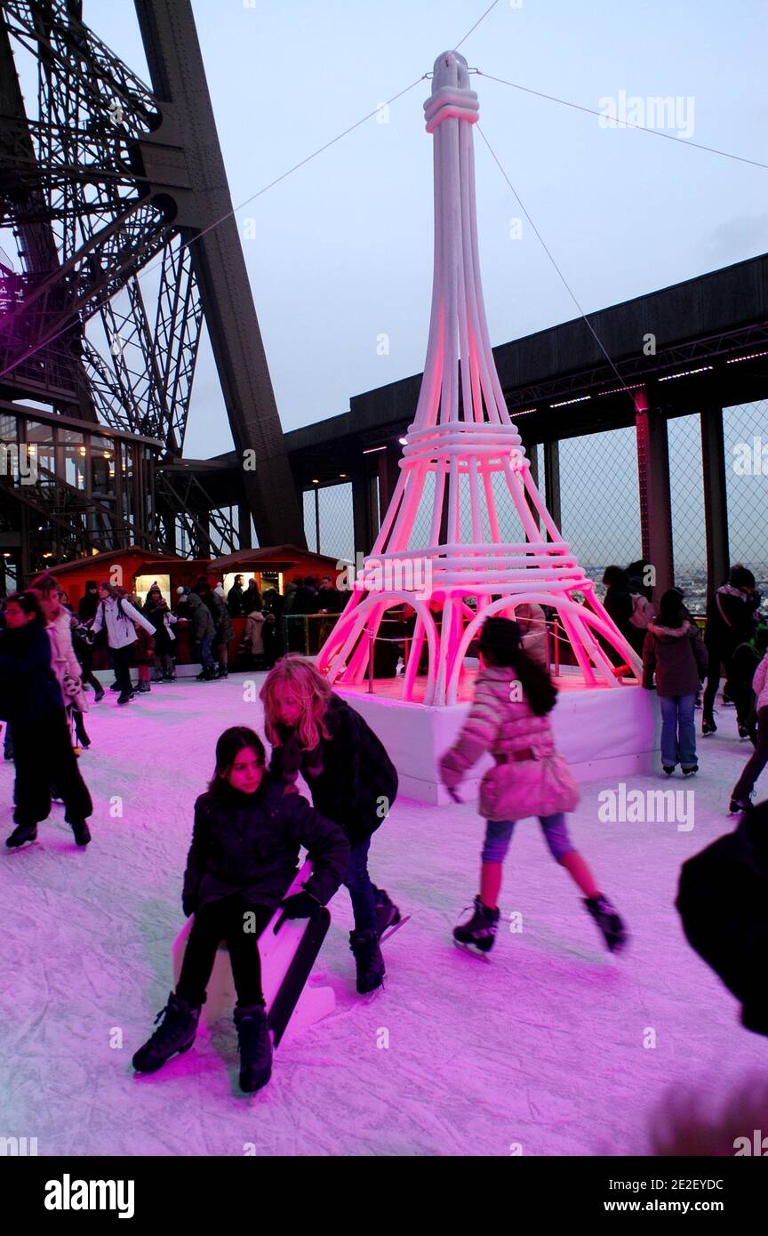 Skaters gliding along the ice on the first floor of the Eiffel Tower, 57 meters above ground level, on the first floor of the Eiffel Tower in Paris, France, December 20, 2011. The rink will only be in operation until February 1st. It is the second consecutive year that the ice skating rink opens in the Eiffel Tower. At 200 square meters (2,150 sq feet), it is only about a third of the size of New York's famed Rockefeller Center ice rink. Last year, more than 1,000 skaters visited the Tower's frozen surface, dubbed 'a popular success,' by organizers of the initiative. Skates can be hired for 5 Stock Photo