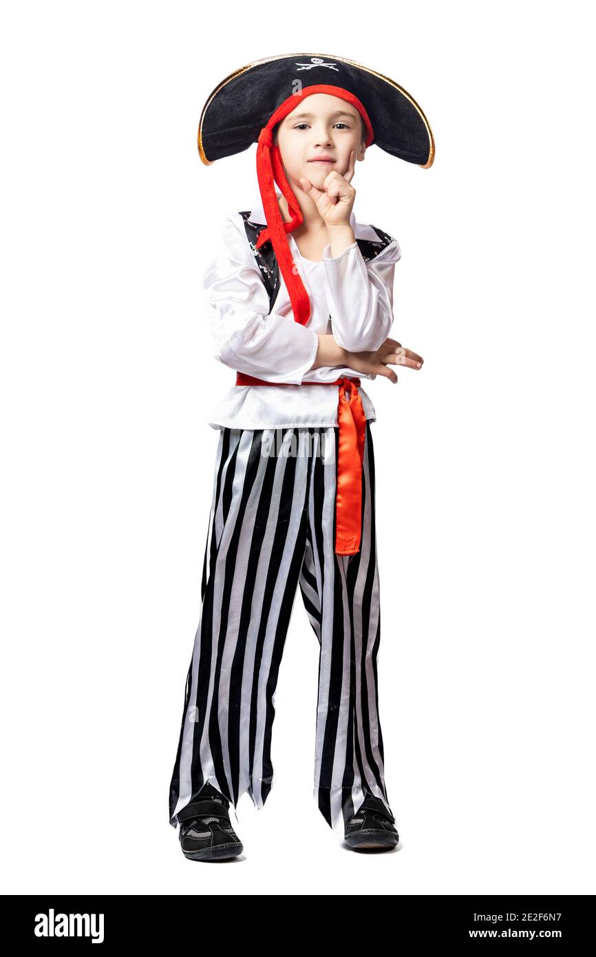 Portrait of a smiling boy in a pirate costume and hat posing, pretending to be pensive and looking slyly on white isolated background. Children's cost Stock Photo