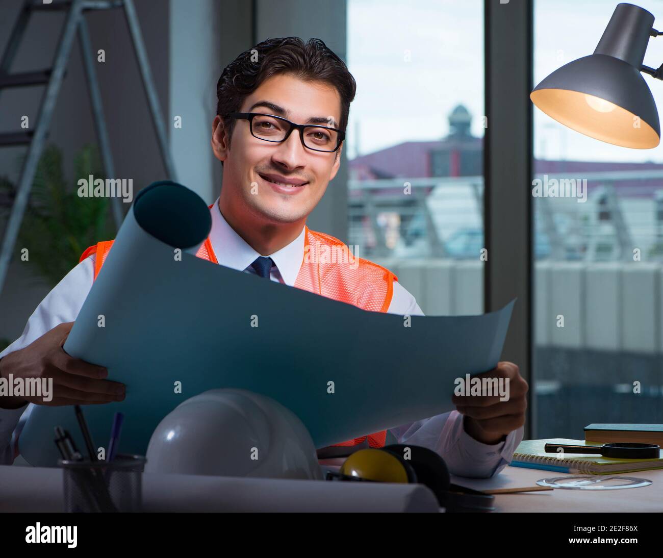 The construction architect working on drawings late at night Stock Photo