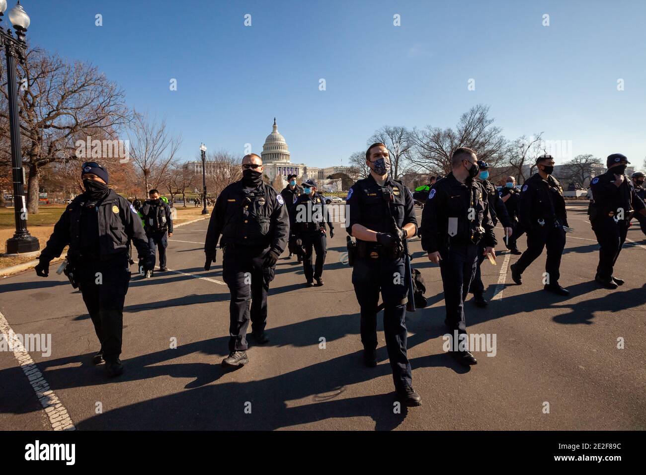 Washington, DC, USA, 13 January, 2021.  Pictured: 13 of the roughly 50 Capitol Police that forced 30 protesters out of an open, public area at the Capitol during Shutdown DC's Expel All Fascists protest.   Protesters wrote the names of Representatives and Senators who objected to certification of the presidential election results on January 6 on three large banners.  The banners called expulsion of all fascists from Congress.  Credit: Allison C Bailey/Alamy Live News Stock Photo