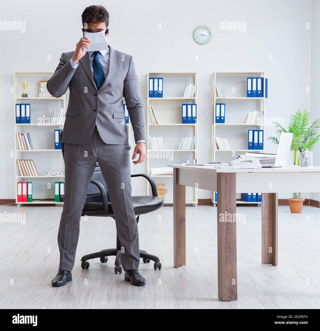 The businessman exercising in office wearing vr glasses Stock Photo - Alamy