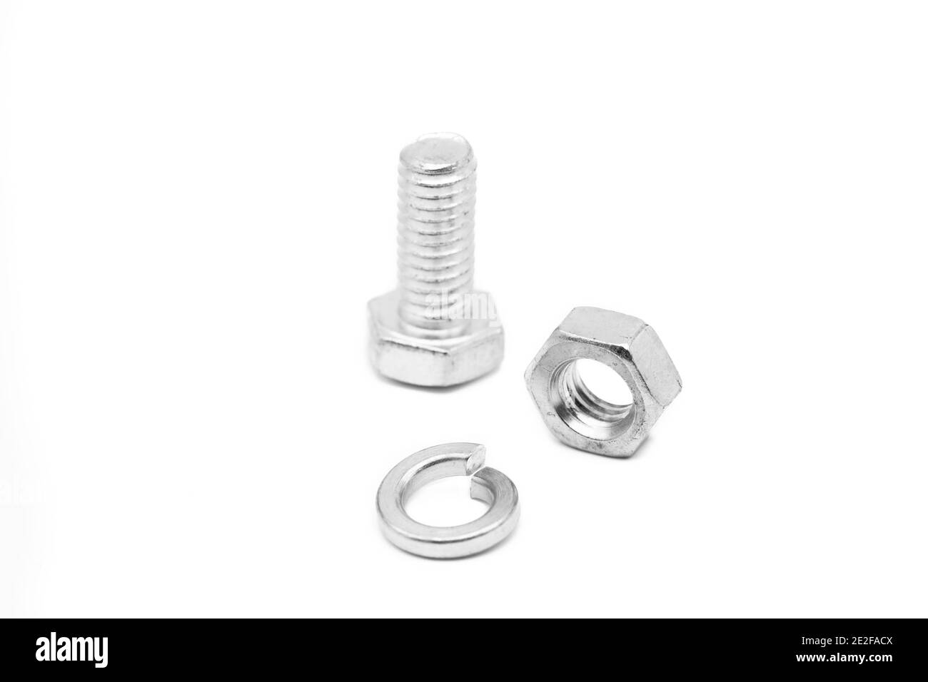 Closeup of nut and bolts isolated on a white background Stock Photo